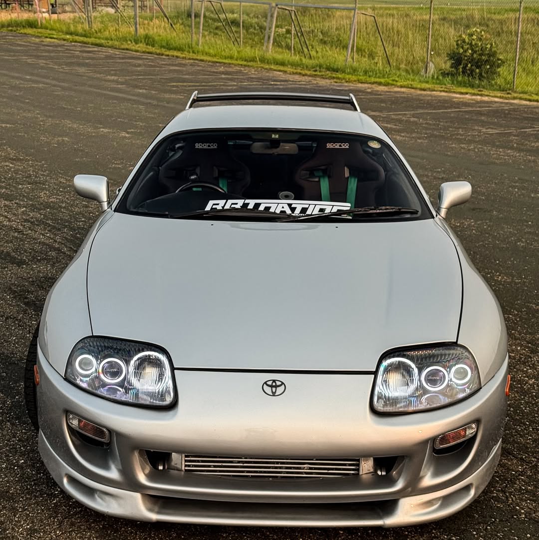 Silver Toyota Supra photographed from the front at golden hour